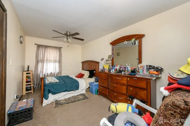 a bedroom with furniture and a window