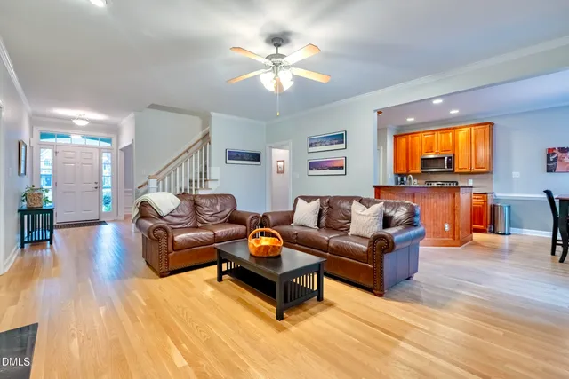 a kitchen with stainless steel appliances granite countertop wooden cabinets a stove a sink and a microwave