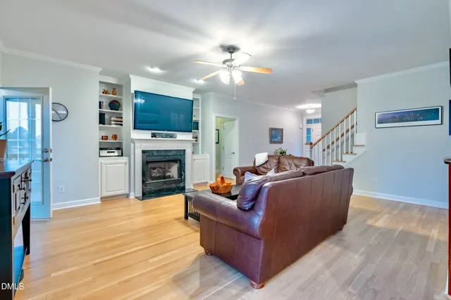 a dining room with furniture window entryway and wooden floor