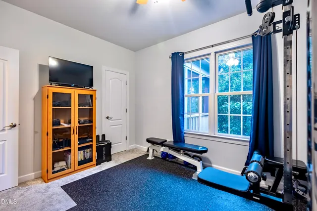 an aerial view of a house with swimming pool and outdoor seating