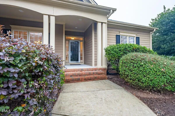 a dining room with wooden floor a chandelier a wooden table and chairs