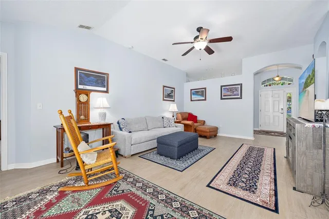 a dining room with stainless steel appliances kitchen island granite countertop a dining table chairs and a refrigerator