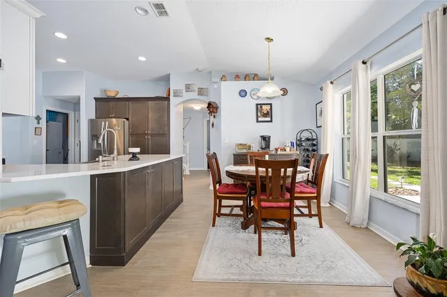 a metallic refrigerator freezer sitting in a kitchen