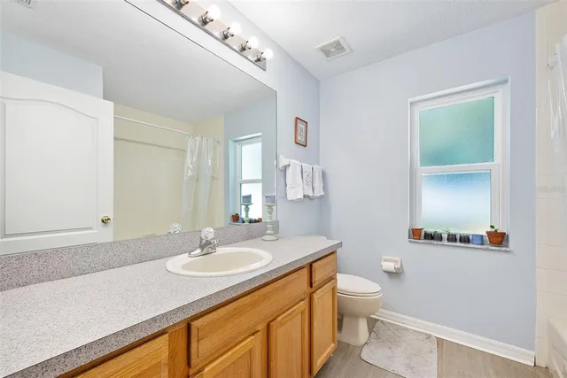 a bedroom with a bed and a chair in it