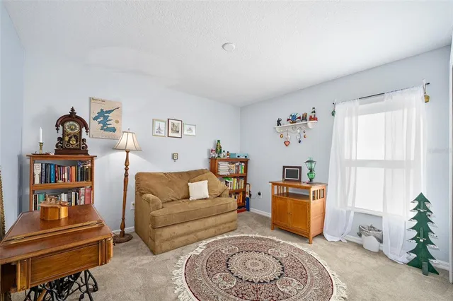 a bedroom with a bed and a lamp on dresser