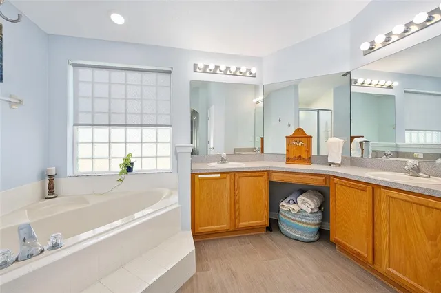 an aerial view of residential houses with outdoor space and trees