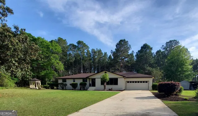 a view of house with garden space and trees