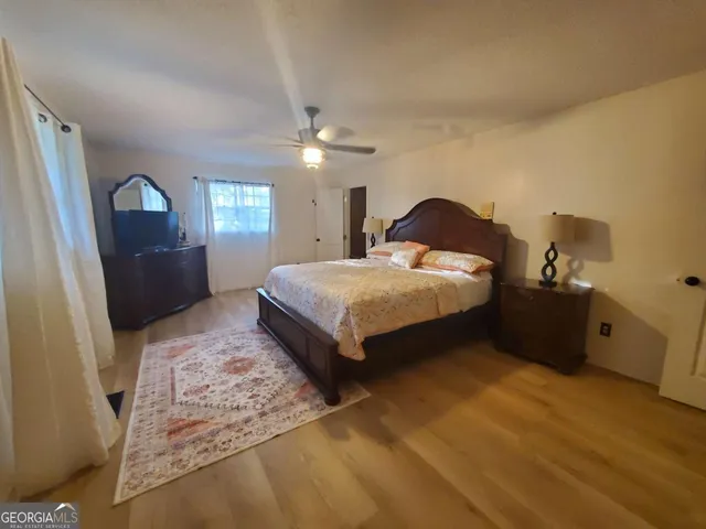 a bedroom with a bed and window