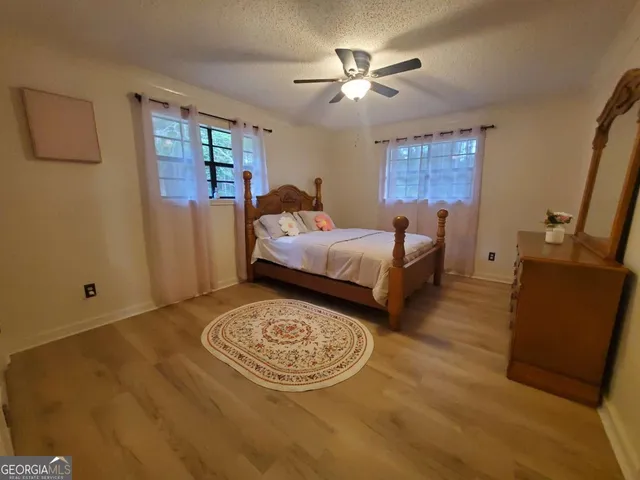 a bed room with a bed and a chandelier