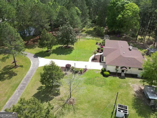 an aerial view of a house with yard swimming pool and outdoor seating
