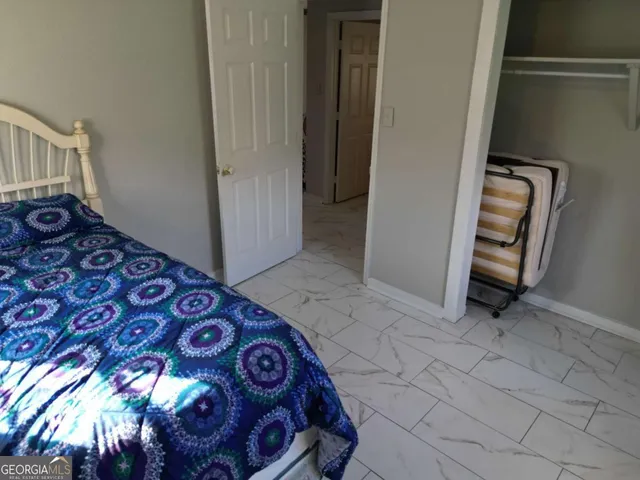 a bed sitting in a bedroom next to a window