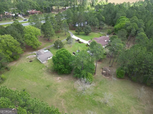 a backyard of a house with a yard and outdoor seating