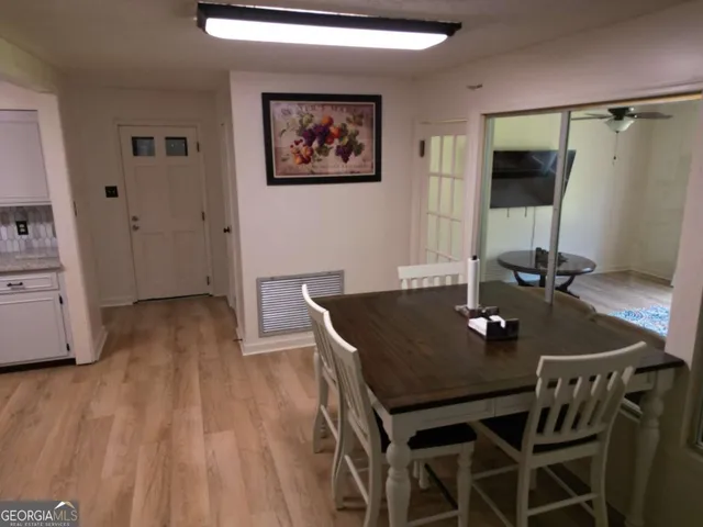 a view of a dining room with furniture and wooden floor