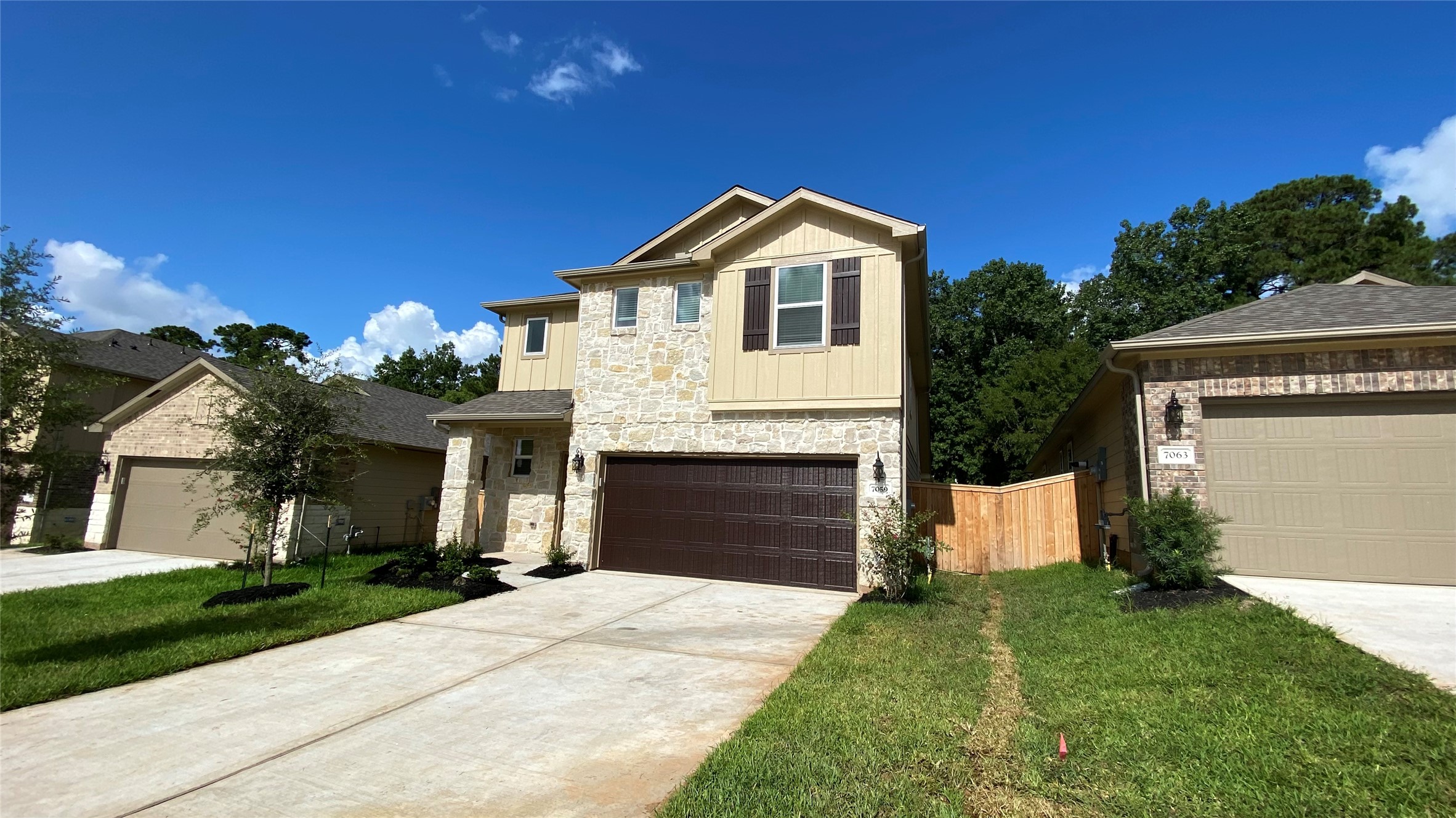7059 Silverleaf Oak Street Conroe, TX 77304 - Photo 1 of 29 a front view of a house with a yard and garage