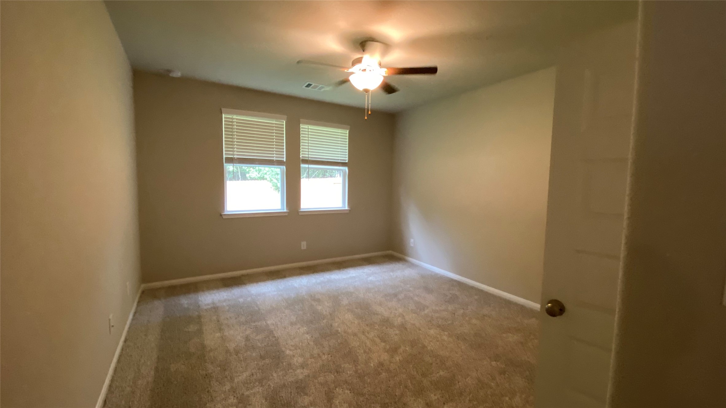 7059 Silverleaf Oak Street Conroe, TX 77304 - Photo 12 of 29 a view of an empty room with a window