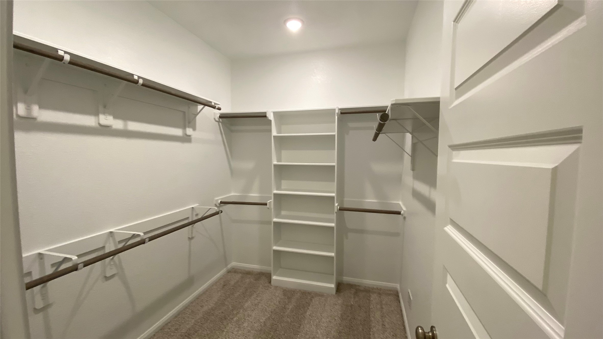 7059 Silverleaf Oak Street Conroe, TX 77304 - Photo 13 of 29 a view of walk in closet with empty racks