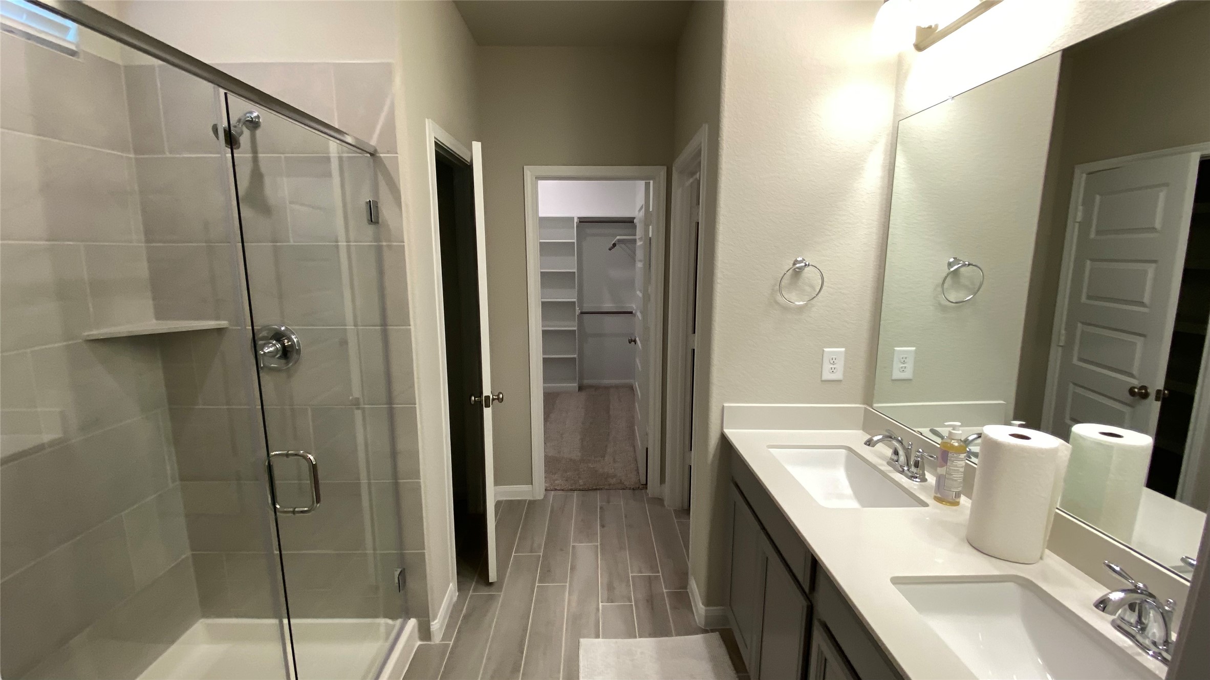 7059 Silverleaf Oak Street Conroe, TX 77304 - Photo 16 of 29 a bathroom with a granite countertop sink a mirror and shower
