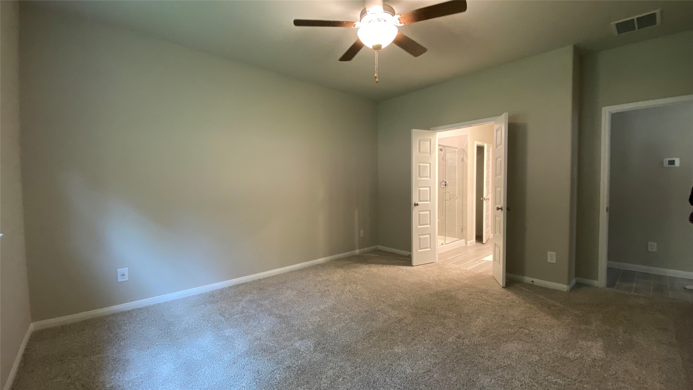 7059 Silverleaf Oak Street Conroe, TX 77304 - Photo 17 of 29 an empty room with a chandelier fan and windows