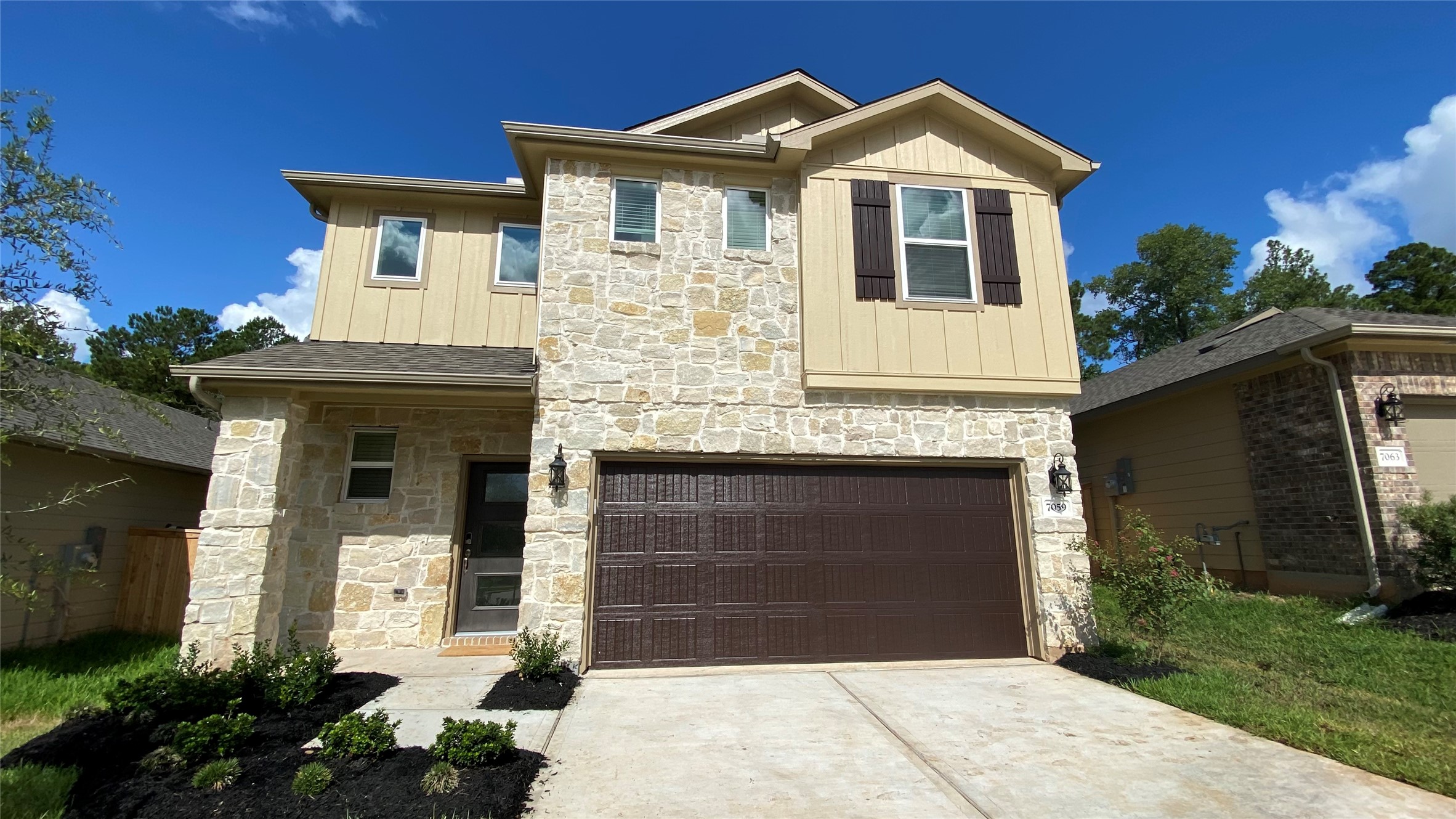 7059 Silverleaf Oak Street Conroe, TX 77304 - Photo 2 of 29 a front view of a house with a yard