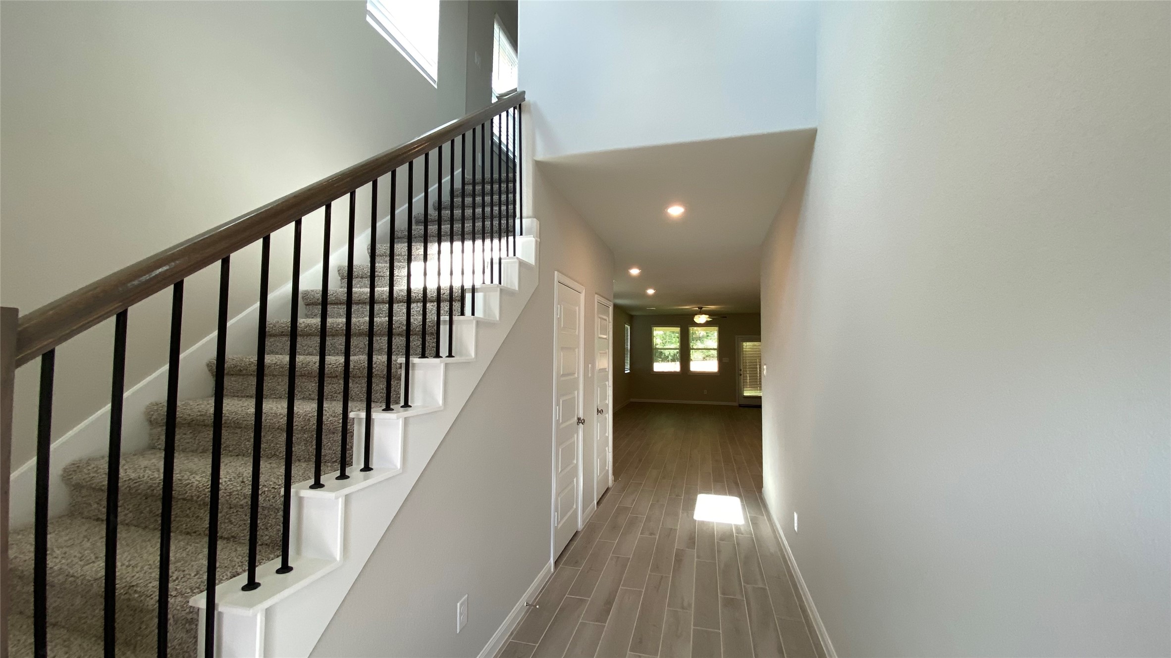 7059 Silverleaf Oak Street Conroe, TX 77304 - Photo 5 of 29 a view of a hallway with wooden floor and stairs