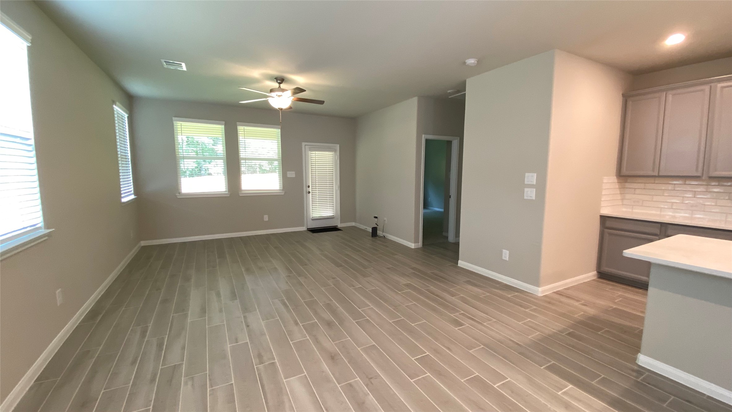 7059 Silverleaf Oak Street Conroe, TX 77304 - Photo 9 of 29 wooden floor in an empty room with a window