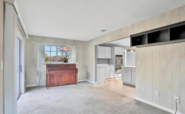 a kitchen with stainless steel appliances kitchen island granite countertop a refrigerator and a stove top oven