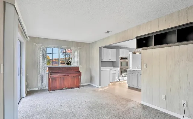 a kitchen with stainless steel appliances kitchen island granite countertop a refrigerator and a stove top oven