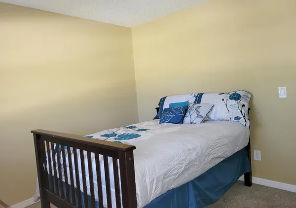 a bedroom with a bed and chair