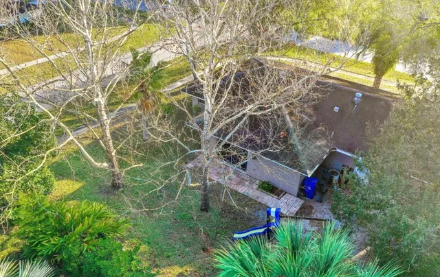 a backyard of a house with lots of green space and a fountain