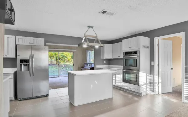 a kitchen with stainless steel appliances a refrigerator sink and stove