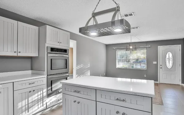 a kitchen with cabinets and window