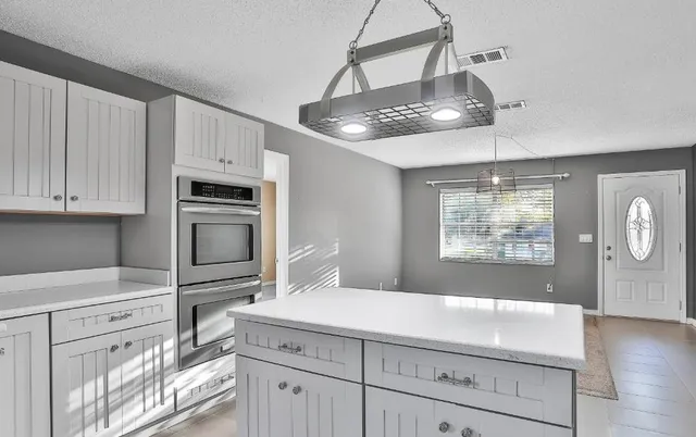 a kitchen with cabinets and window