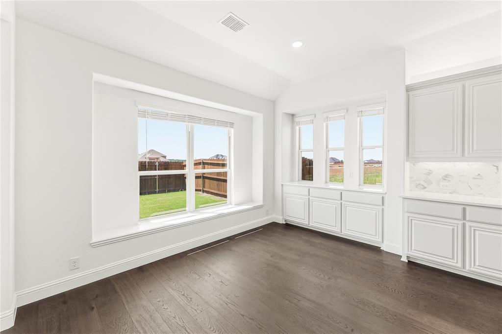1145 Hitching Post Way Oak Point, TX 75068 - Photo 21 of 39 a view of an empty room with a window and wooden floor