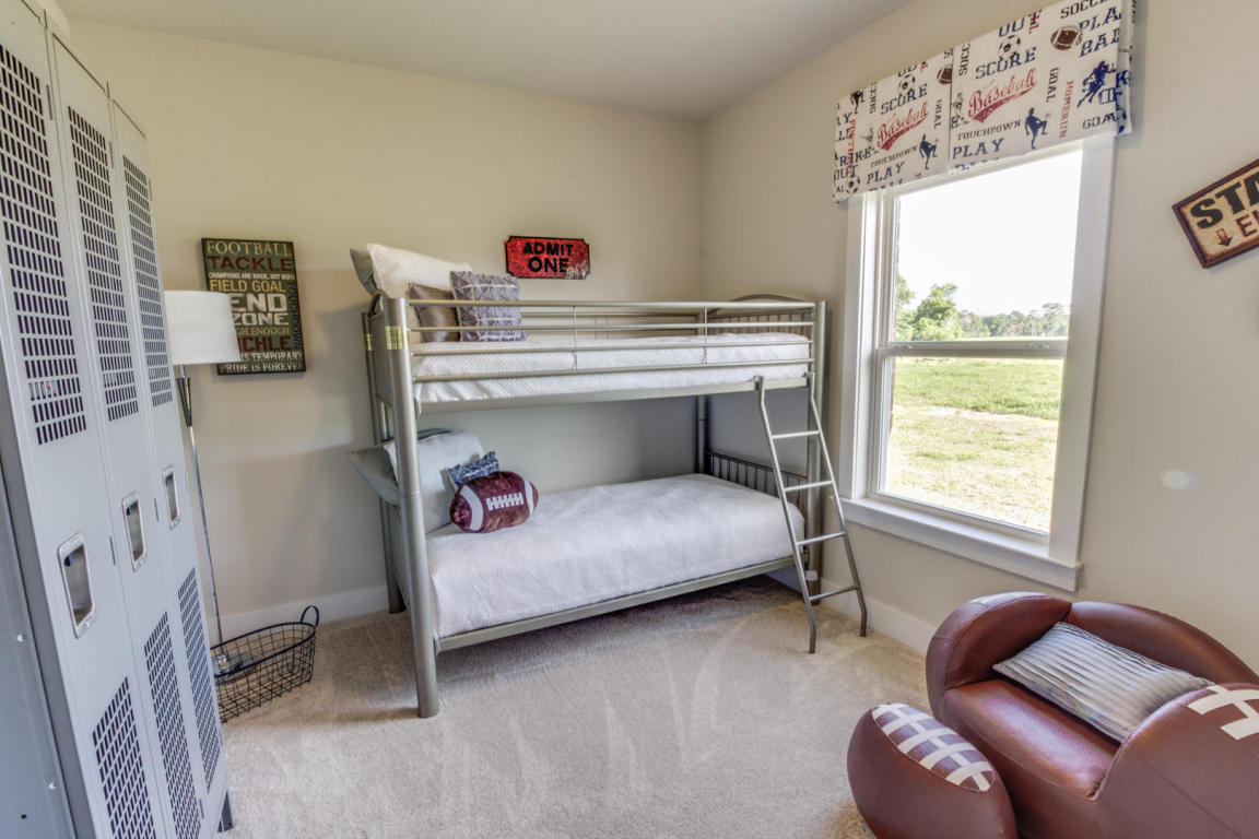 405 Chickadee Street Crestview, FL 32539 - Photo 11 of 16 a bedroom with furniture and a window