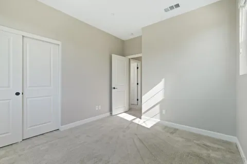 an aerial view of residential houses with outdoor space and trees