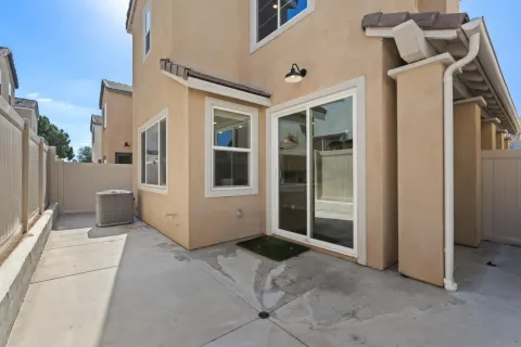 a building outdoor space with patio furniture and potted plants
