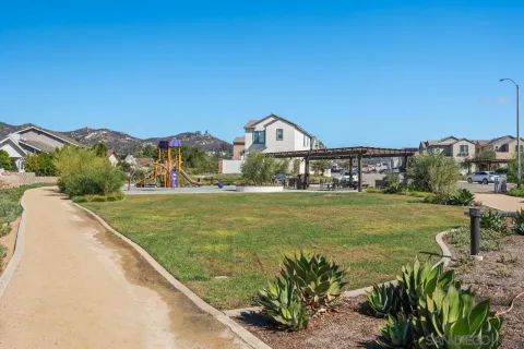 a view of a street with a house in the background