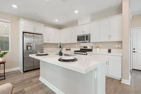 a kitchen with stainless steel appliances granite countertop a sink a stove a microwave and cabinets