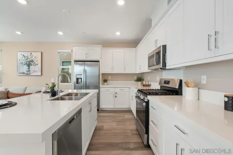 a kitchen with appliances a sink and cabinets