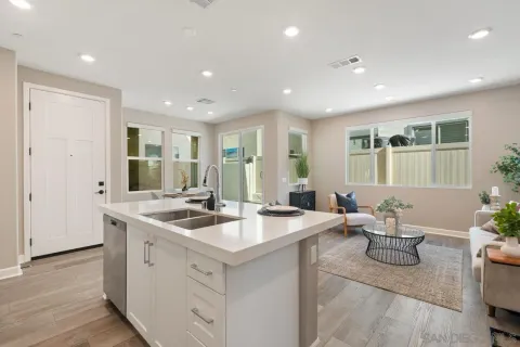 a living room with furniture and a refrigerator