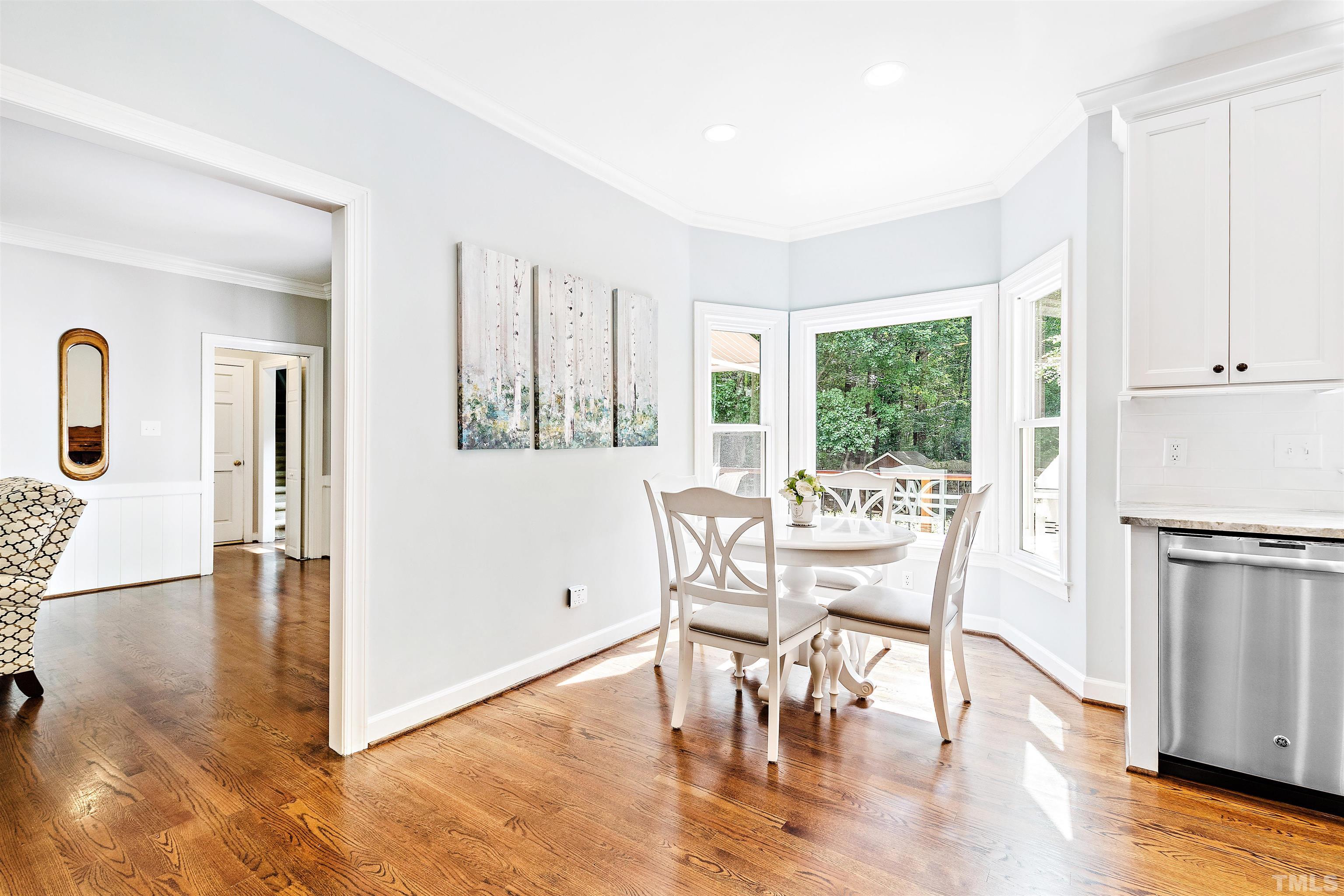 4708 Fallswood Place Raleigh, NC 27613 - Photo 11 of 45 a dining room with furniture window wooden floor