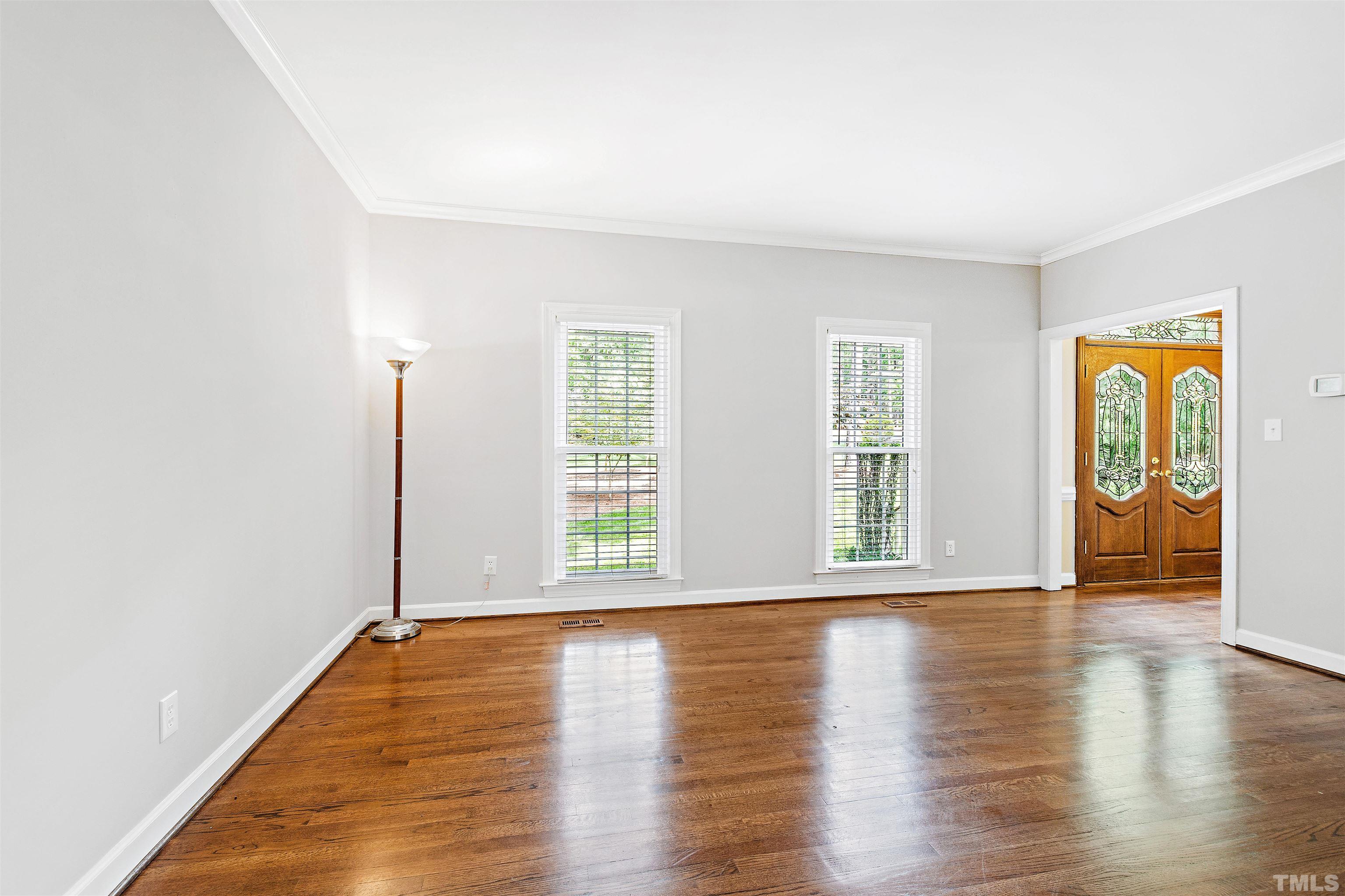 4708 Fallswood Place Raleigh, NC 27613 - Photo 18 of 45 a view of an empty room with wooden floor and a window