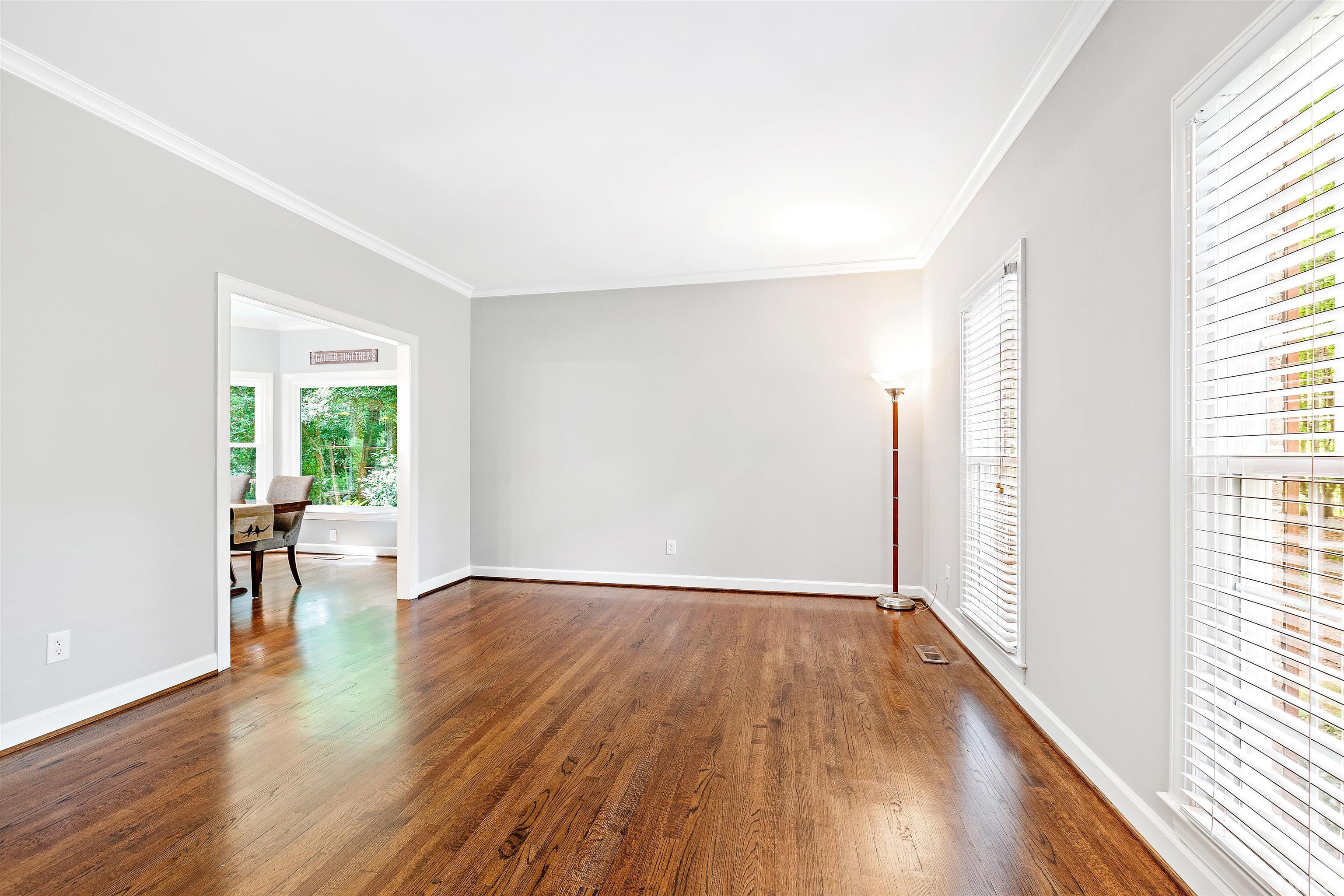 4708 Fallswood Place Raleigh, NC 27613 - Photo 19 of 45 a view of an empty room with wooden floor and a window