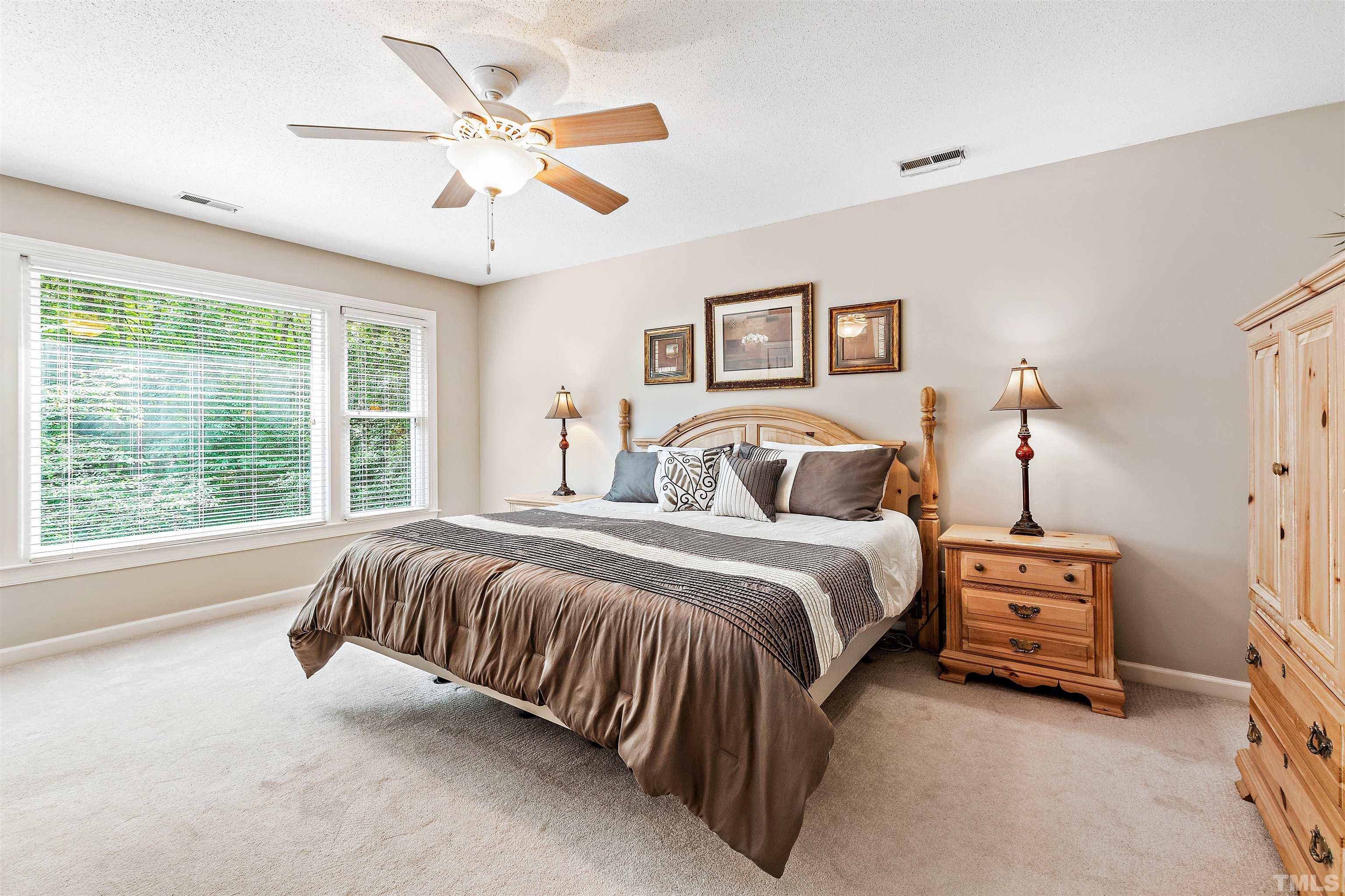 4708 Fallswood Place Raleigh, NC 27613 - Photo 24 of 45 a spacious bedroom with a bed and a large window