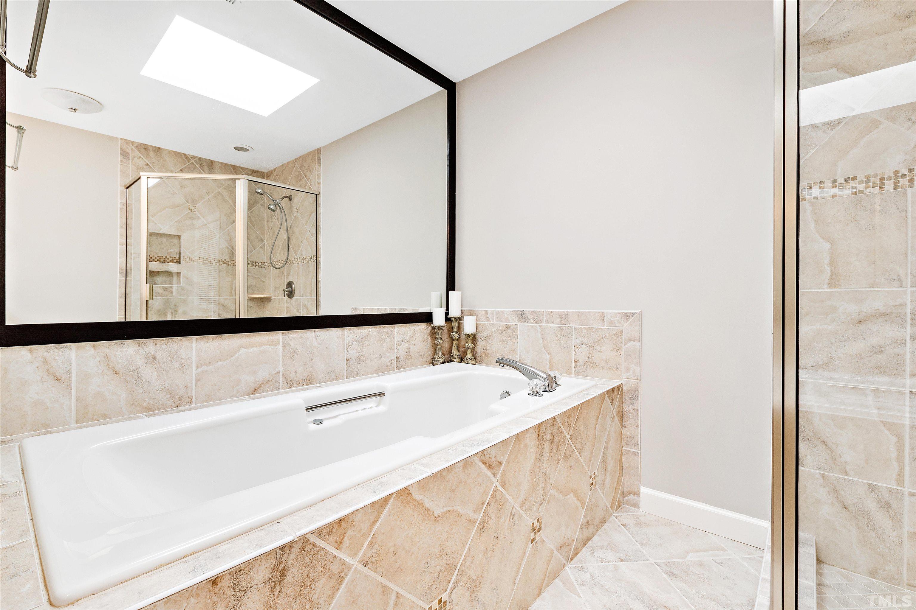 4708 Fallswood Place Raleigh, NC 27613 - Photo 26 of 45 a spacious bathroom with a bathtub and a sink