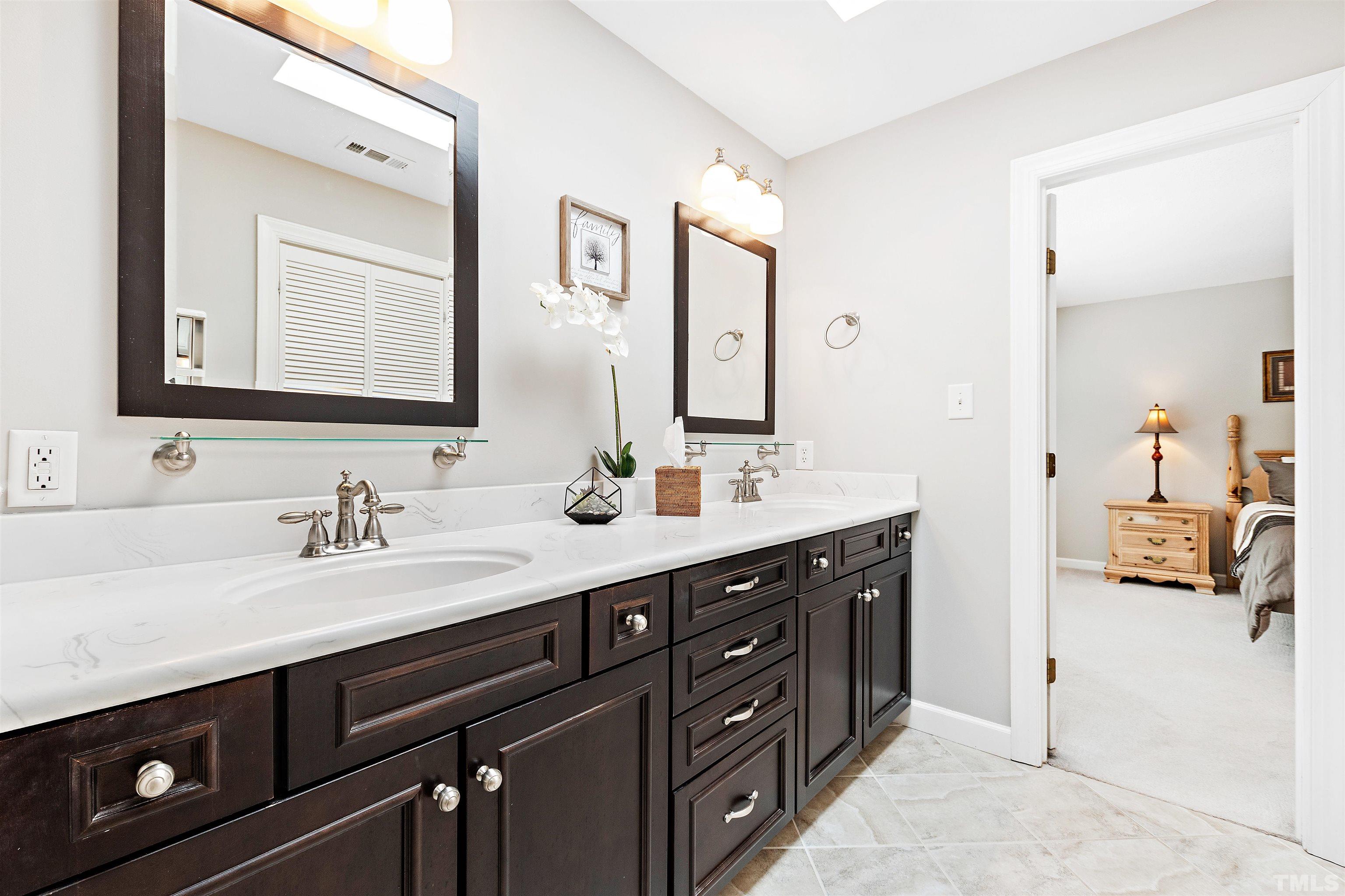 4708 Fallswood Place Raleigh, NC 27613 - Photo 27 of 45 a bathroom with a sink double vanity and a mirror