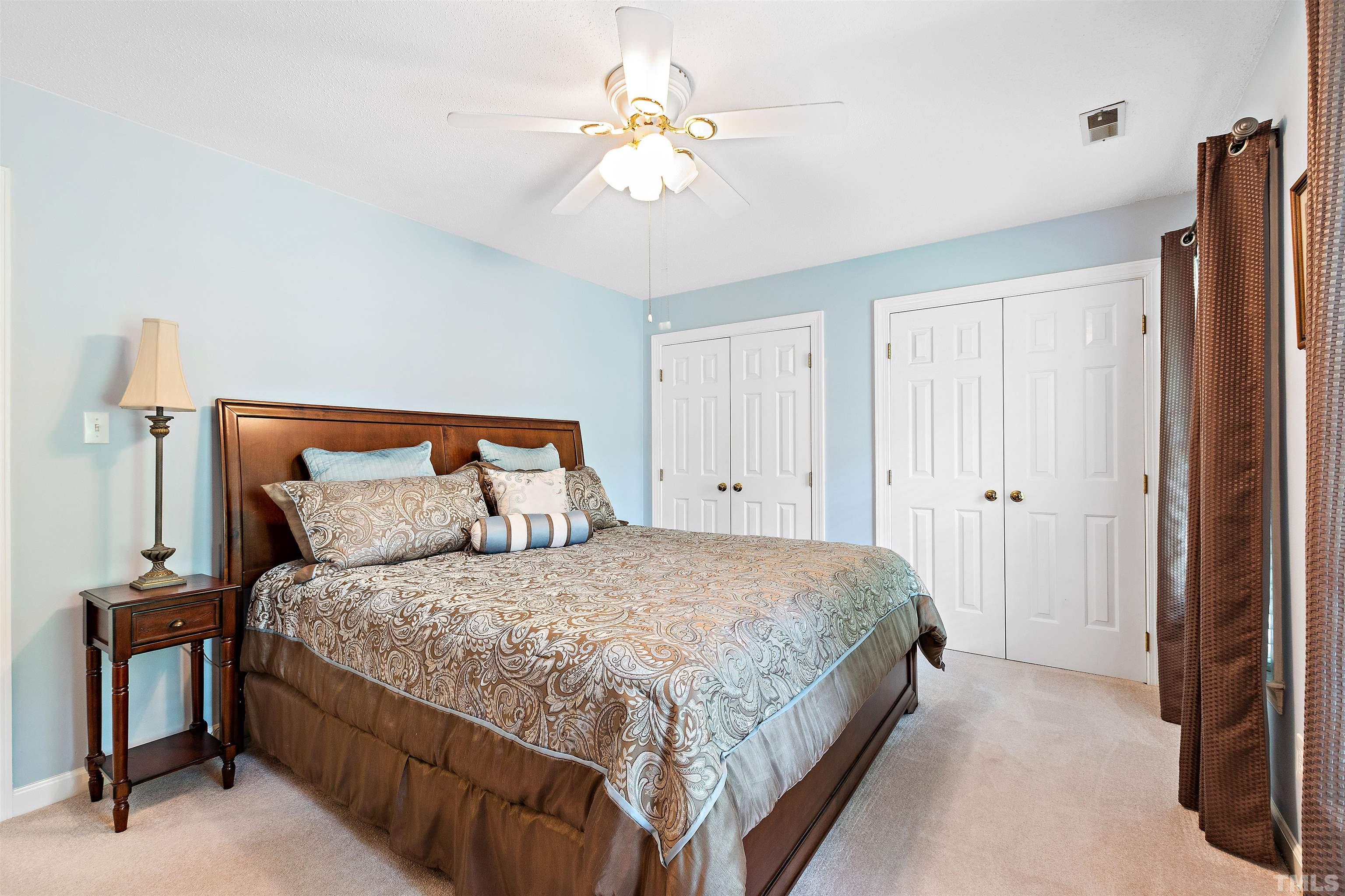 4708 Fallswood Place Raleigh, NC 27613 - Photo 28 of 45 a bedroom with a bed and a chandelier