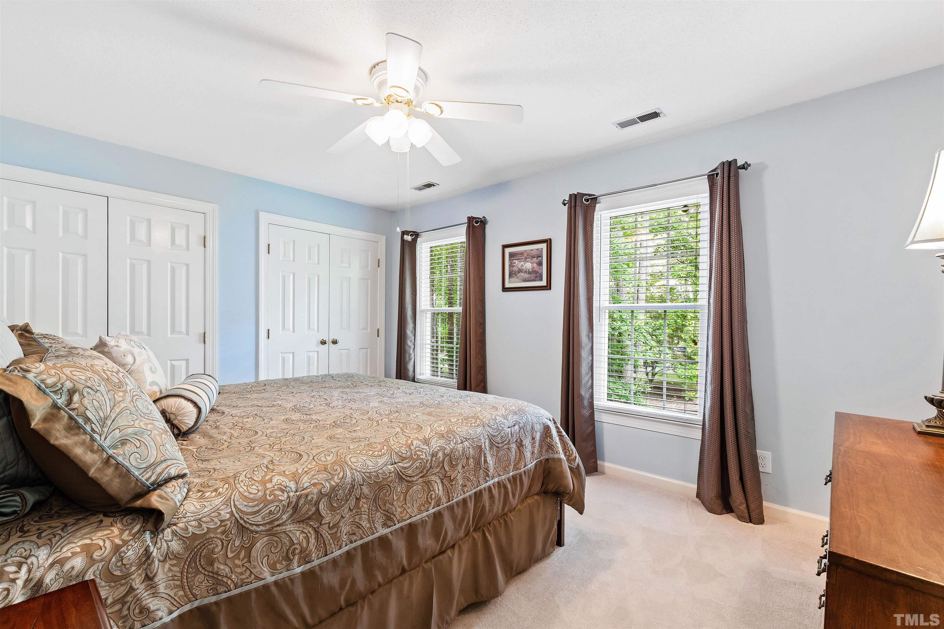 4708 Fallswood Place Raleigh, NC 27613 - Photo 29 of 45 a bedroom with a bed and a chandelier