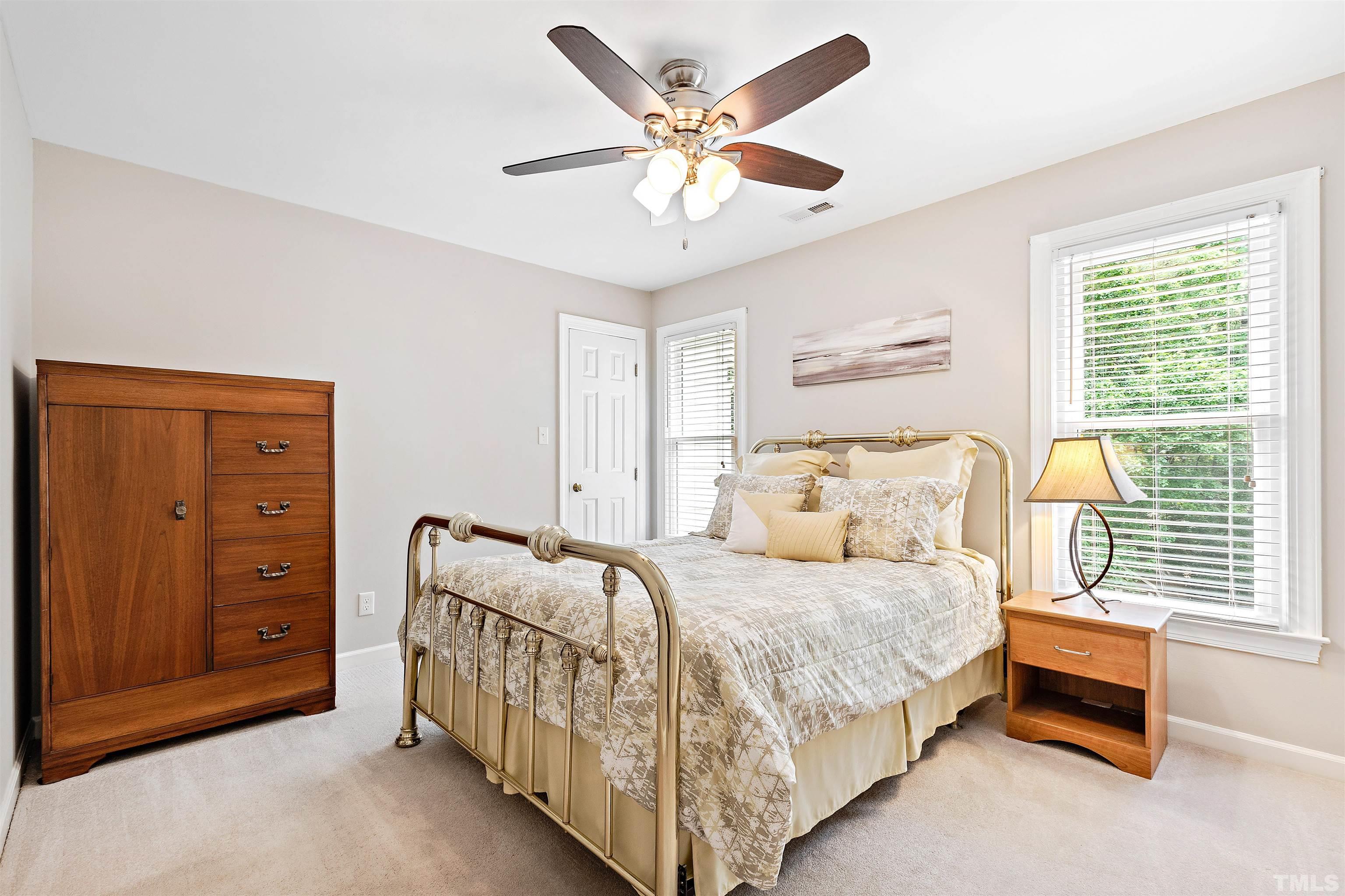 4708 Fallswood Place Raleigh, NC 27613 - Photo 30 of 45 a bedroom with a bed and a chandelier