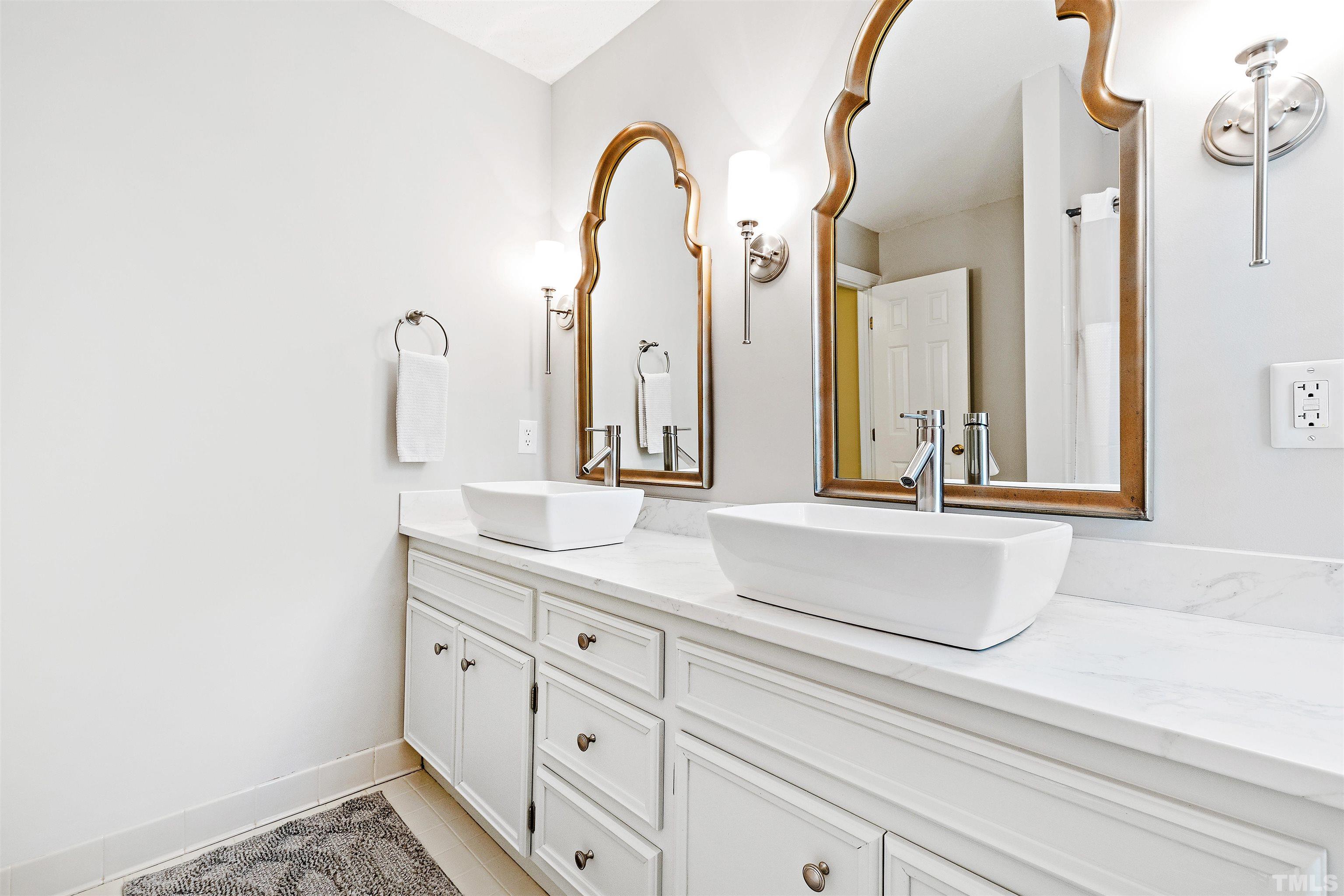 4708 Fallswood Place Raleigh, NC 27613 - Photo 33 of 45 a bathroom with a sink and a mirror